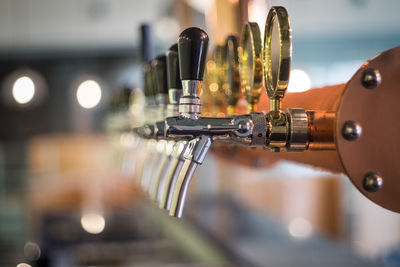 Close-up of beer taps in bar