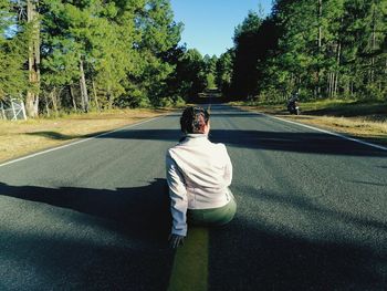 Rear view of man on road