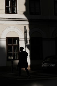 Rear view of silhouette man walking in building