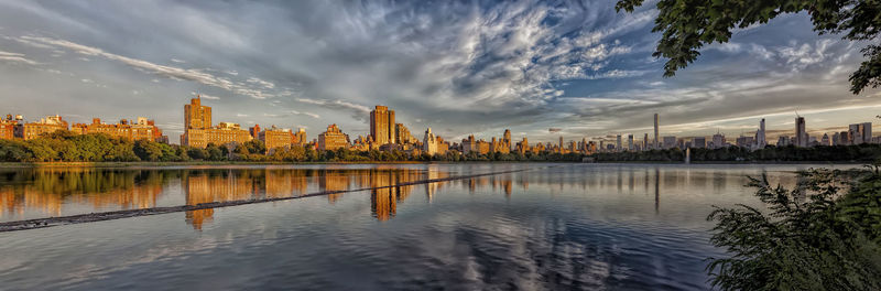 Panoramic view of city against cloudy sky