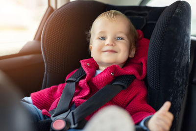 Portrait of cute baby girl in car