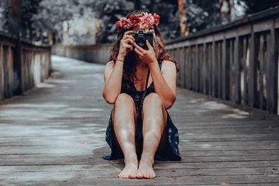 Portrait of young woman sitting outdoors