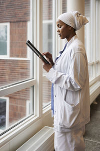 Young female doctor using tablet at work