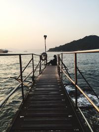 Pier over sea against clear sky