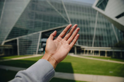 Close-up of hand holding office building