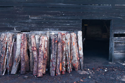 Logs arranged against warehouse