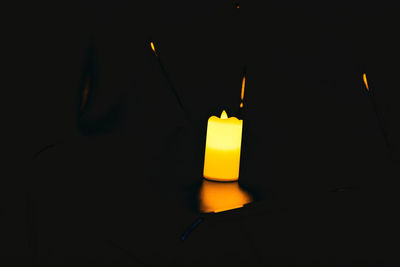 Close-up of illuminated lamp against black background