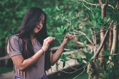 Midsection of woman holding plant