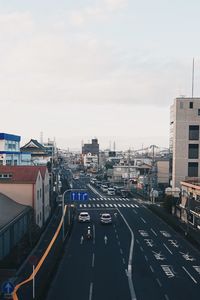 High angle view of city street and buildings against sky