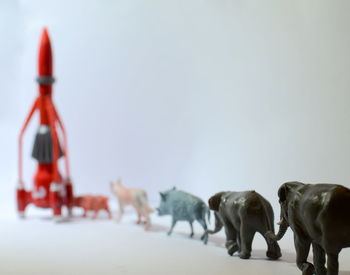 Toy animals and rocket on table