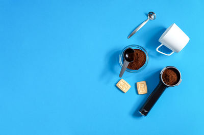 High angle view of coffee cup against blue background