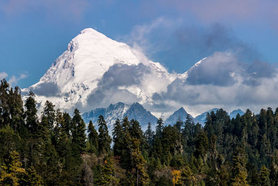 Scenic view of mountains against cloudy sky