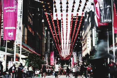 People walking in illuminated city at night