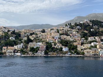 Townscape by sea against sky