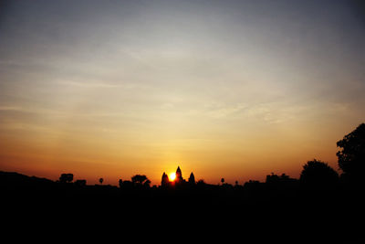 Silhouette trees against sky during sunset