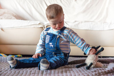 Close-up of cute physically impaired boy with toy