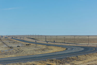 Scenic view of road against clear blue sky