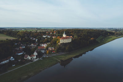 High angle view of townscape by sea against sky