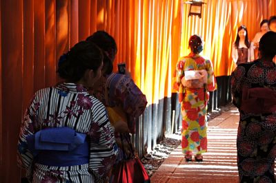 Rear view of couple standing against curtain