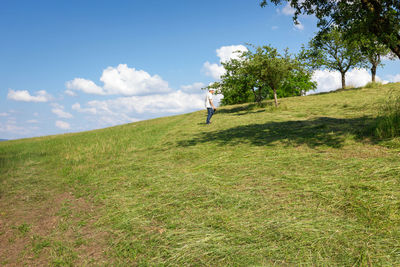 Man on field against sky