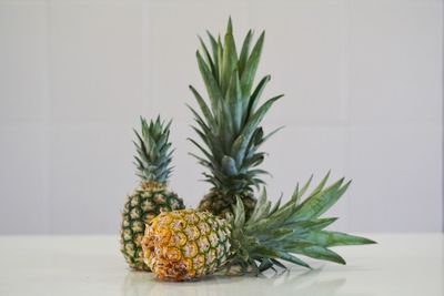 Close-up of fruits on table against wall