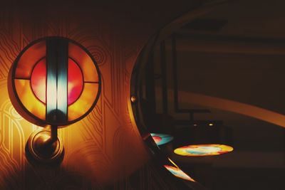 Close-up of illuminated lamp on table