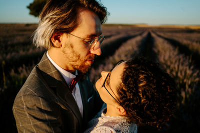 Portrait of couple kissing on field