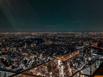 High angle view of illuminated city buildings at night