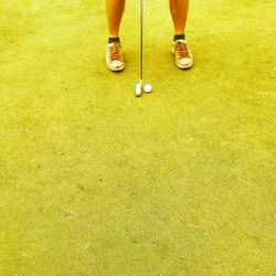 Low section of man standing on golf course