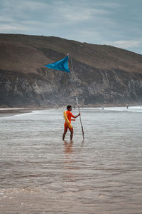 Man surfing in sea against sky