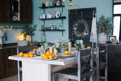 Stylish christmas table with tangerines for new year celebrations