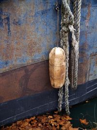 Close-up of rope tied on metal wall