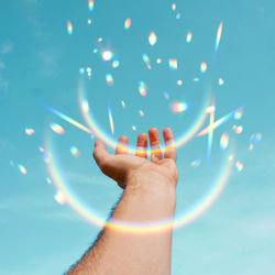 Low section of woman holding illuminated string lights