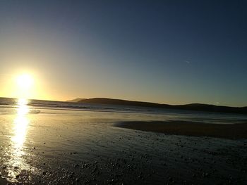 Scenic view of beach against sky during sunset