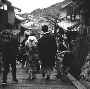Rear view of people standing on street