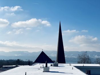 Built structure on snow covered land against sky