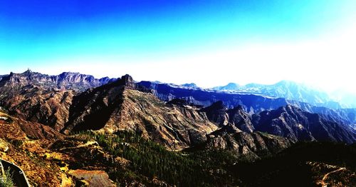 Scenic view of mountains against clear blue sky