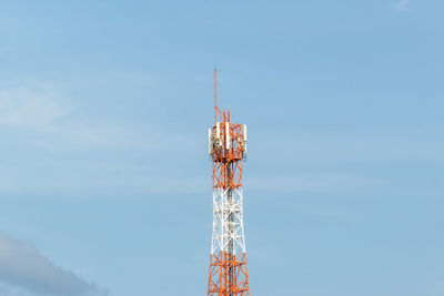 Low angle view of communications tower against sky