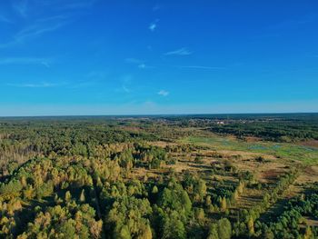 Scenic view of landscape against blue sky