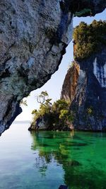 Rock formations by sea against sky