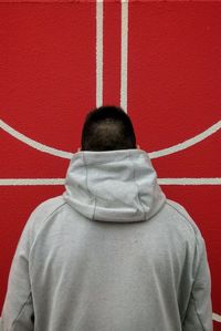 Rear view of teenage boy wearing gray hood