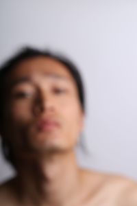 Close-up portrait of young woman over white background