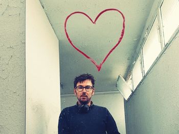 Portrait of man standing in heart shape