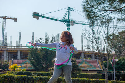 Girl playing with ribbon outdoors