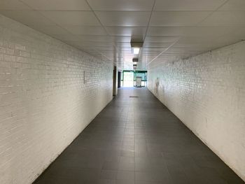 Empty corridor in illuminated building