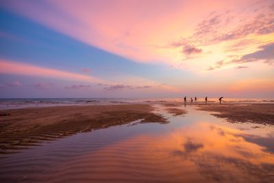 Scenic view of beach against sky during sunset