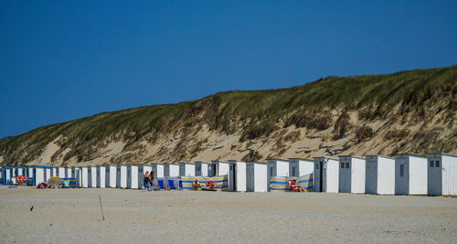 Scenic view of beach against clear blue sky