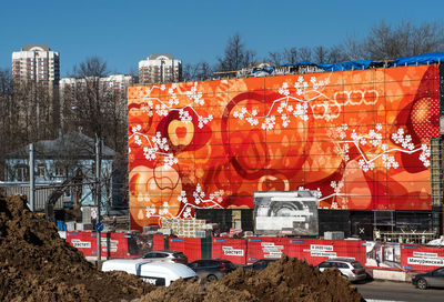 Graffiti on road against sky in city