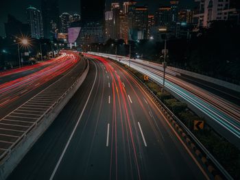 High angle view of light trails on road at night