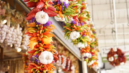 Low angle view of garlic with chili peppers hanging at pike place market